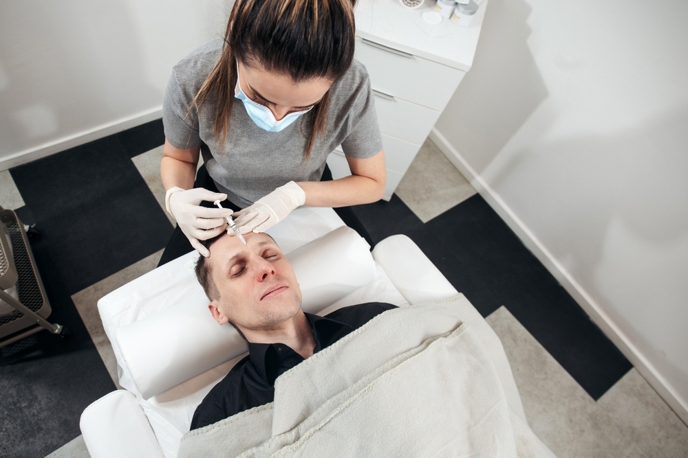 Man receiving a peptide therapy injection from a masked healthcare provider during a clinical treatment session representing peptide therapy for men