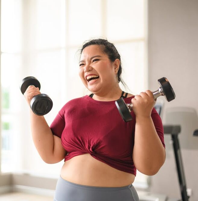 Woman lifting weights at the gym showing motivation and progress supported by a medical weight loss clinic serving Moorestown NJ